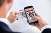 21254207 - close-up of businessman scanning a barcode using cell phone